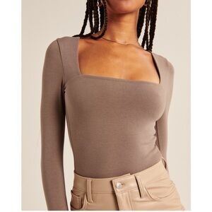 Brown long sleeve fitted bodysuit with square neck and asymmetrical style